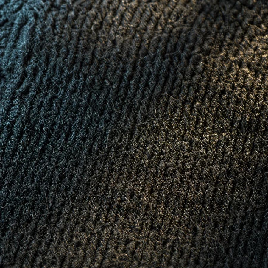 Extreme macro of a knitted foot bed whose surface has sealed into a faintly glazed sheen